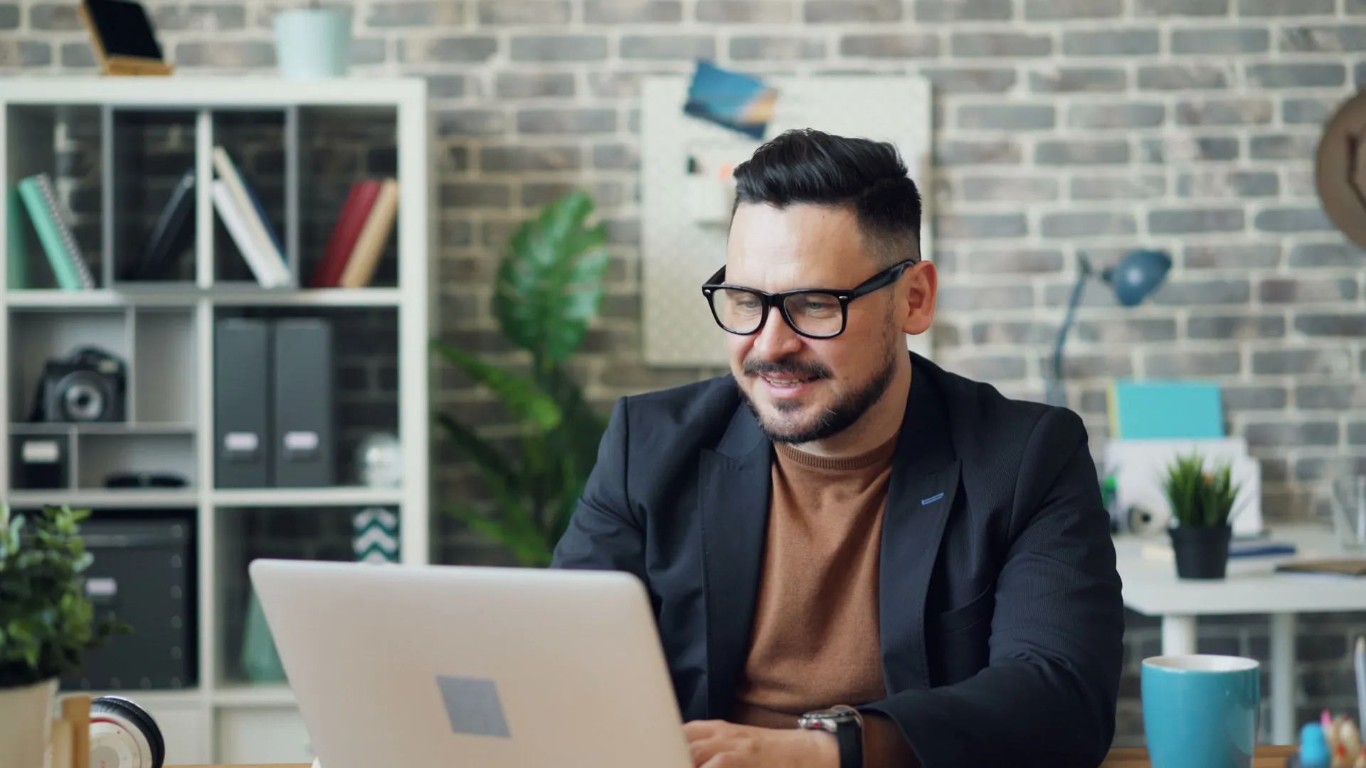 Entrepreneur working on a laptop at a bright desk